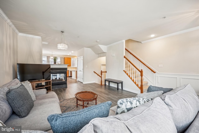 living room with dark wood-type flooring, a multi sided fireplace, and crown molding