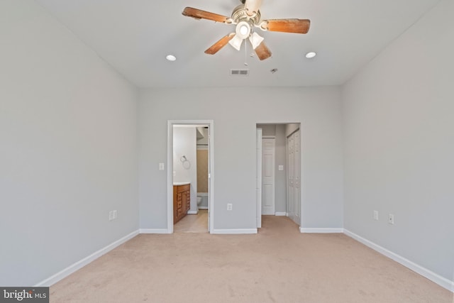 unfurnished bedroom featuring ceiling fan, connected bathroom, and light carpet