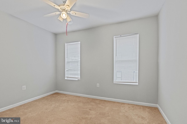 carpeted empty room featuring ceiling fan