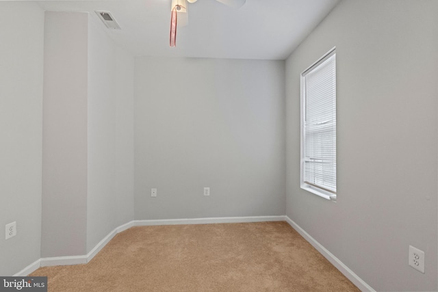 empty room featuring light carpet and ceiling fan