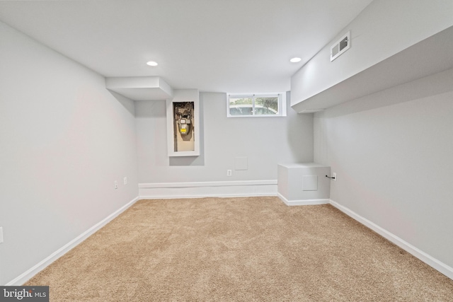 basement featuring light colored carpet