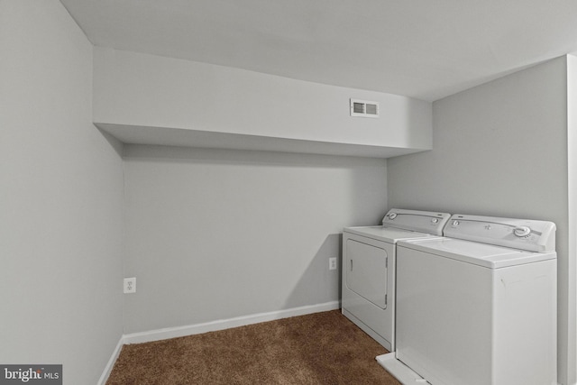 laundry area with dark colored carpet and washing machine and clothes dryer