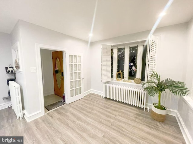 spare room featuring light hardwood / wood-style floors and radiator