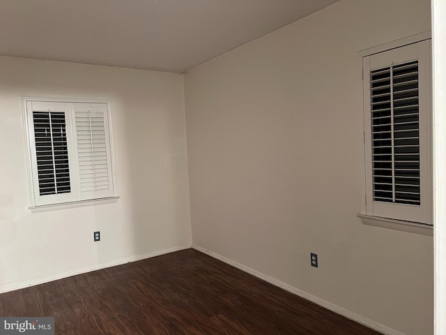 empty room featuring dark wood-type flooring