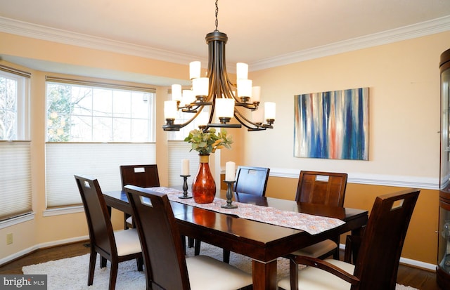 dining space with baseboards and crown molding