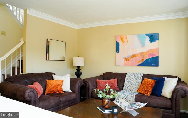 living room with ornamental molding and stairs