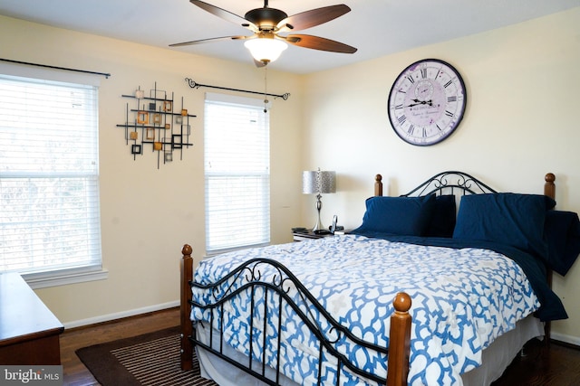 bedroom with a ceiling fan, baseboards, and wood finished floors