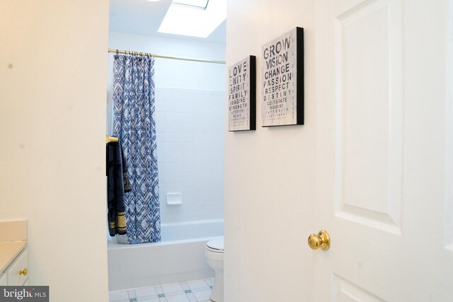 bathroom with toilet, shower / tub combo with curtain, and vanity