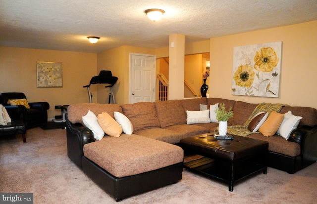 living area with a textured ceiling, stairs, and light colored carpet