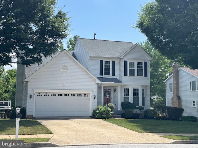 view of front of home with a garage and a front yard