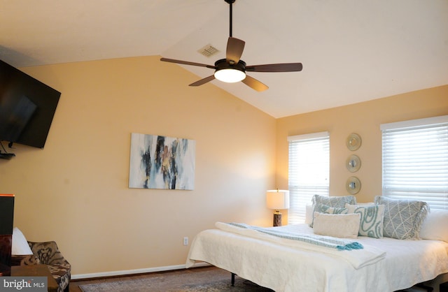 bedroom featuring visible vents, vaulted ceiling, baseboards, and ceiling fan