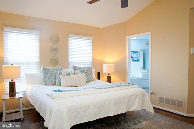 bedroom with dark wood-style floors, visible vents, a ceiling fan, connected bathroom, and vaulted ceiling