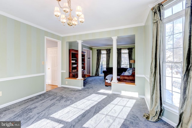 interior space featuring decorative columns, ornamental molding, a wealth of natural light, and an inviting chandelier