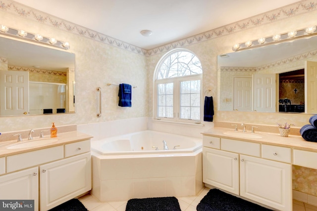 bathroom with tile patterned flooring, vanity, and separate shower and tub