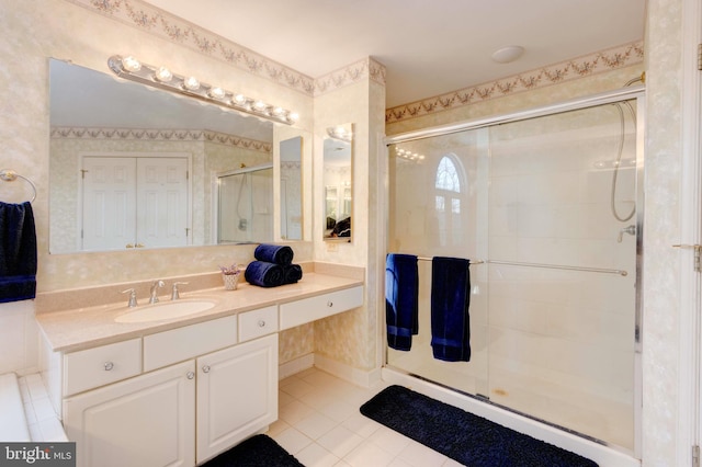 bathroom with vanity, tile patterned floors, and a shower with door