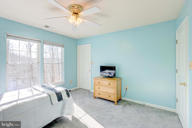 bedroom featuring light carpet and ceiling fan