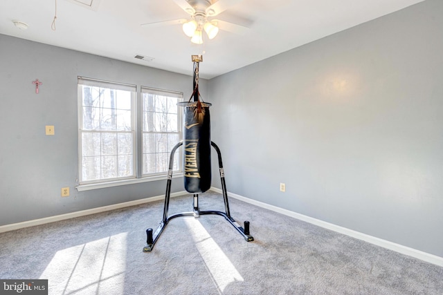 workout area with ceiling fan and carpet flooring