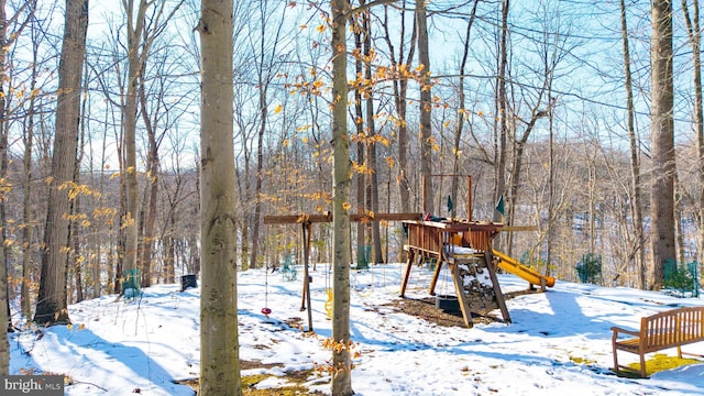 snowy yard with a playground