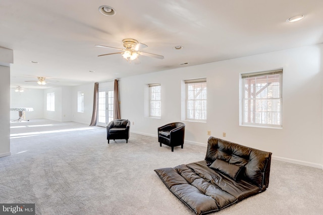 sitting room featuring a wealth of natural light, light colored carpet, and ceiling fan