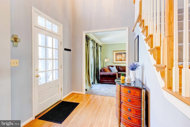 foyer featuring hardwood / wood-style flooring and crown molding