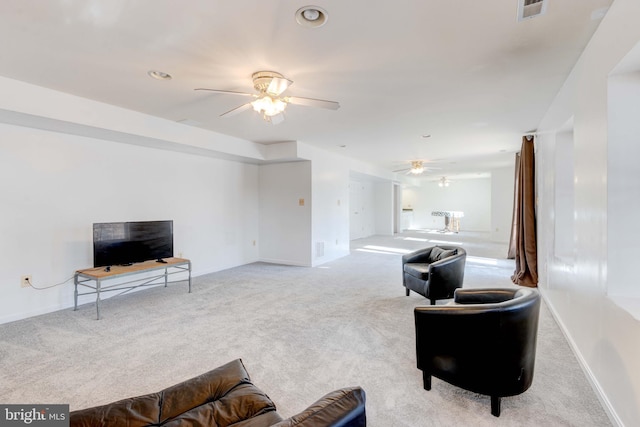 living room with light colored carpet and ceiling fan