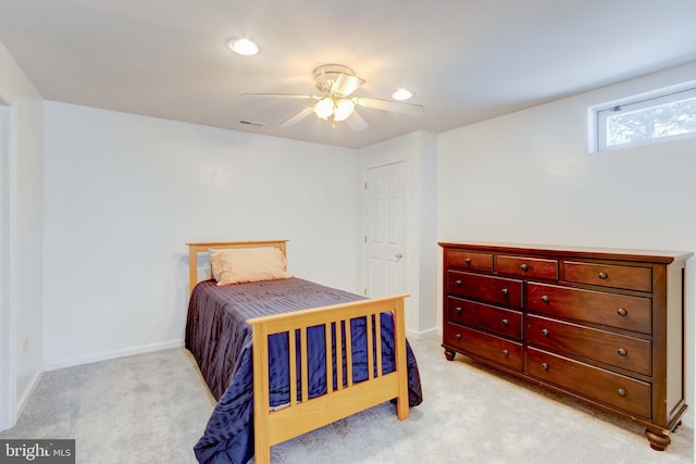 bedroom with light carpet and ceiling fan