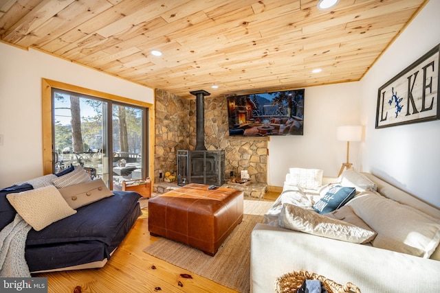 living room featuring hardwood / wood-style flooring, a wood stove, and wood ceiling