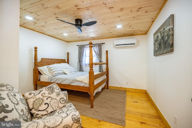 bedroom featuring ceiling fan, an AC wall unit, hardwood / wood-style flooring, and wooden ceiling