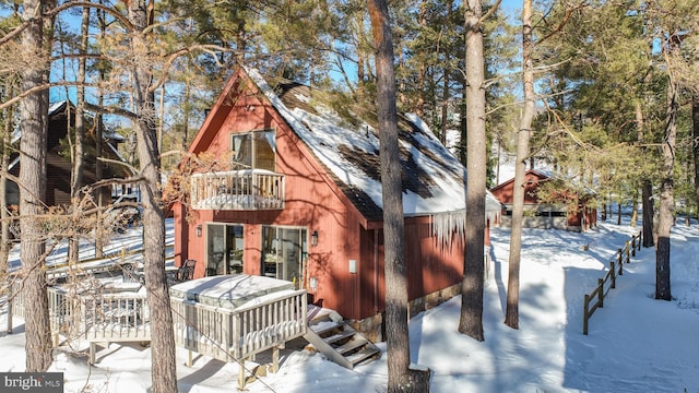 log cabin featuring a balcony