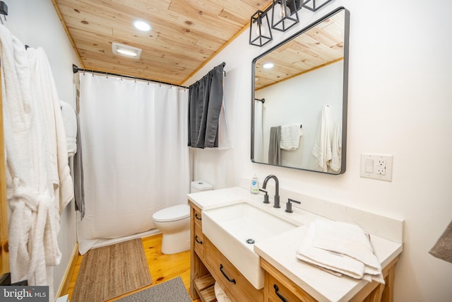 bathroom with hardwood / wood-style flooring, toilet, vanity, and wood ceiling