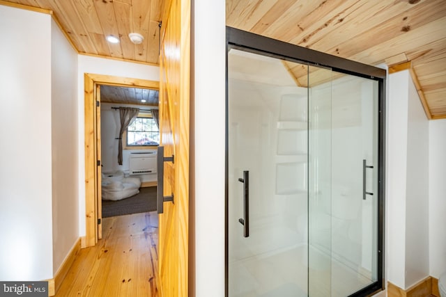 bathroom featuring hardwood / wood-style flooring, walk in shower, and wooden ceiling