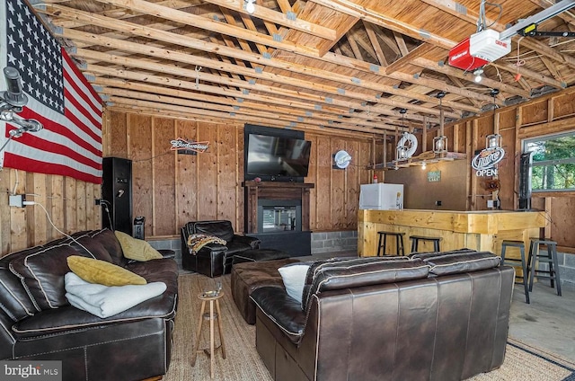 living room featuring concrete floors and wooden walls