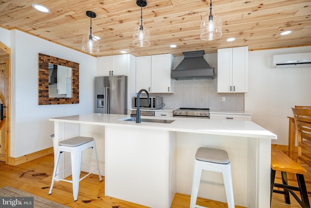 kitchen with appliances with stainless steel finishes, custom range hood, a kitchen breakfast bar, hanging light fixtures, and a wall mounted AC