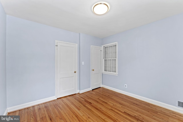 spare room featuring light wood-type flooring