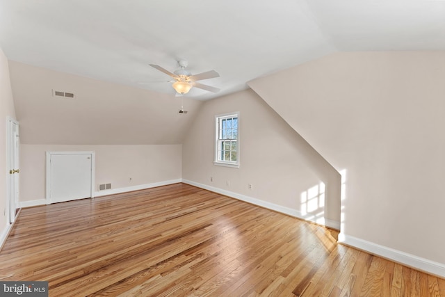 additional living space with vaulted ceiling, ceiling fan, and light hardwood / wood-style floors