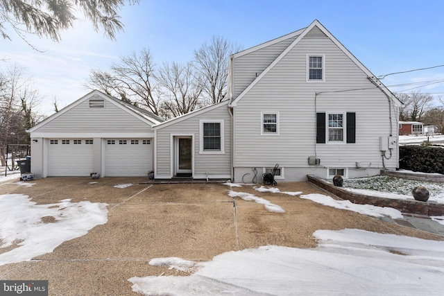 view of snow covered exterior with a garage