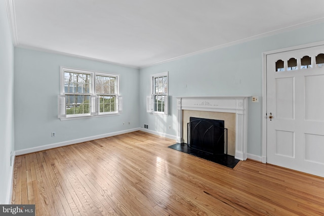 unfurnished living room featuring crown molding and light hardwood / wood-style flooring