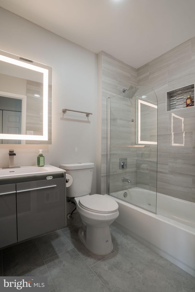 full bathroom with vanity, tile patterned floors, enclosed tub / shower combo, and toilet