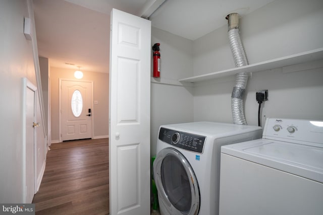 laundry area featuring washing machine and clothes dryer and dark hardwood / wood-style floors