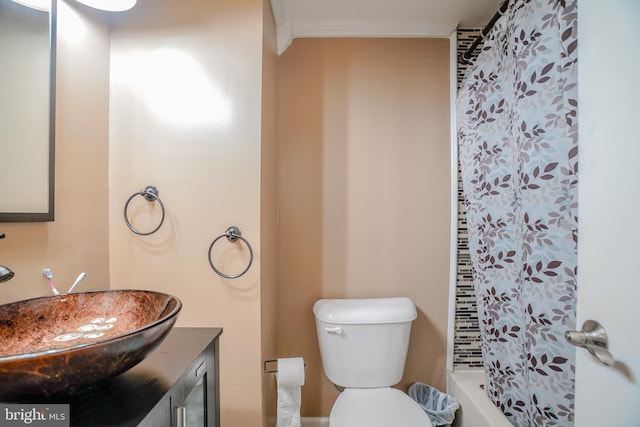 bathroom featuring toilet, ornamental molding, vanity, and curtained shower