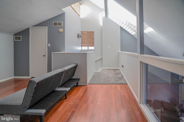 interior space with hardwood / wood-style floors and lofted ceiling