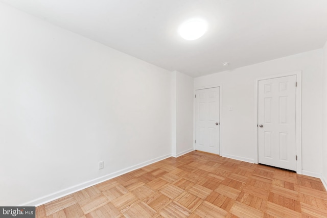 unfurnished bedroom featuring light parquet flooring