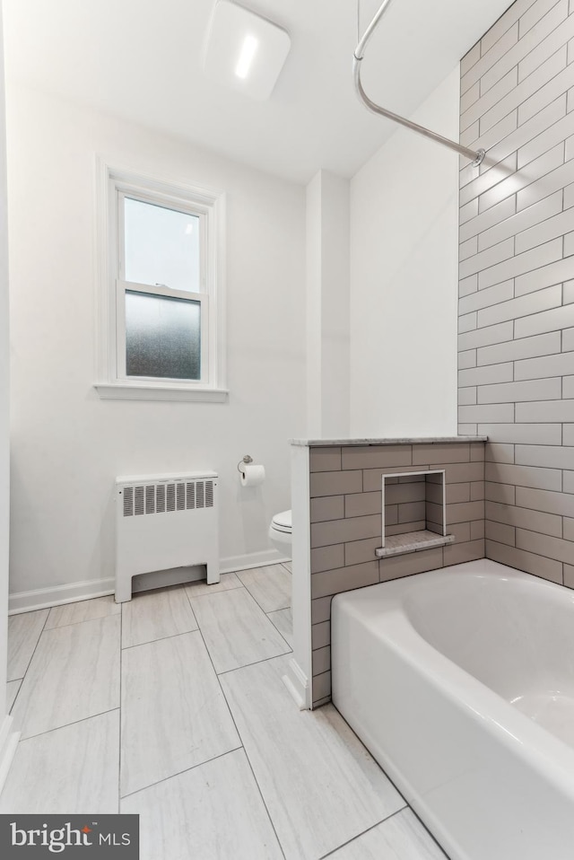 bathroom featuring radiator, toilet, and shower / bathtub combination