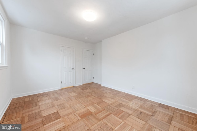 empty room with light parquet flooring