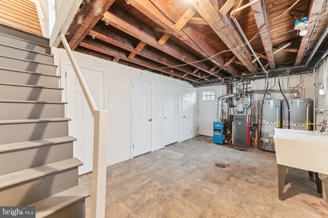 basement featuring sink and water heater