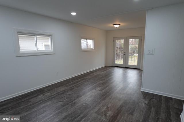 spare room with dark hardwood / wood-style flooring and french doors