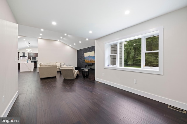 unfurnished living room with dark hardwood / wood-style floors and lofted ceiling