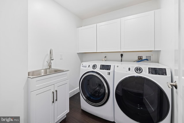 washroom with cabinets, independent washer and dryer, dark hardwood / wood-style floors, and sink