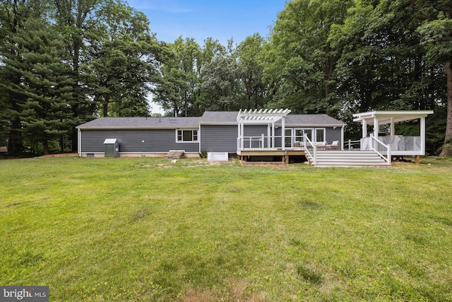 back of house featuring a lawn, a pergola, and a deck