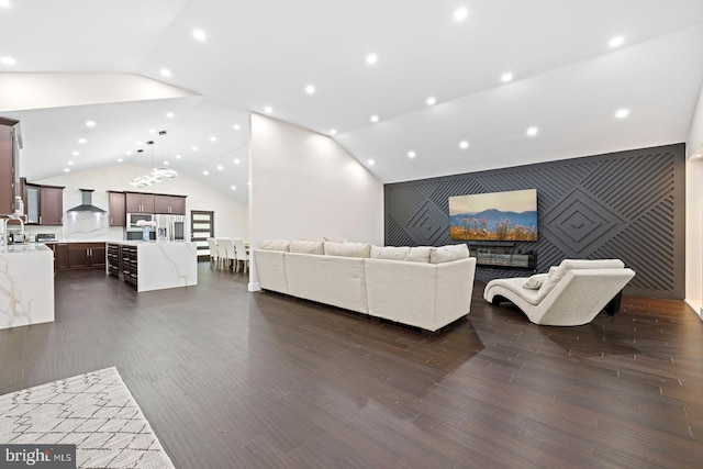 living room with sink, dark hardwood / wood-style floors, and lofted ceiling